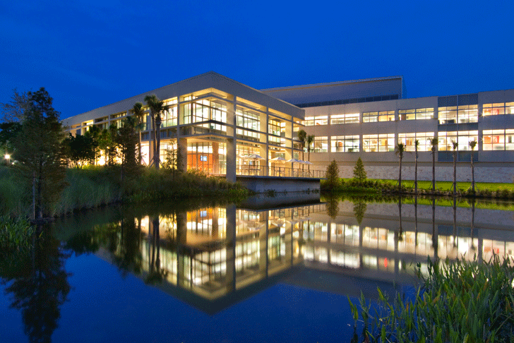 building at night with reflection on lake