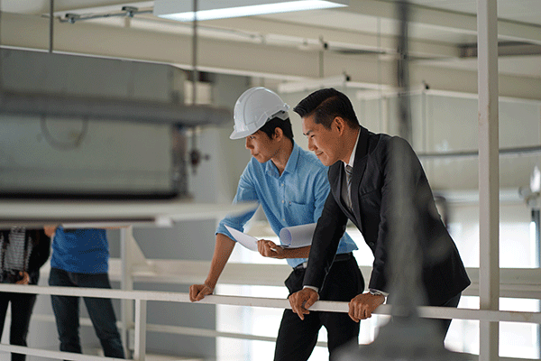 two men assessing facilities